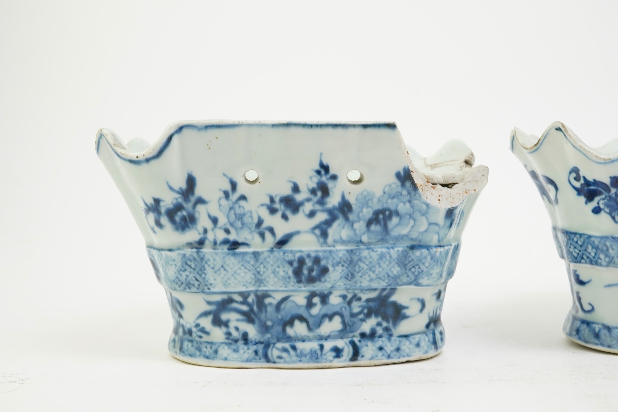 A pair of unusual Chinese export blue and white bough pots, after a Delft model, Qianlong period